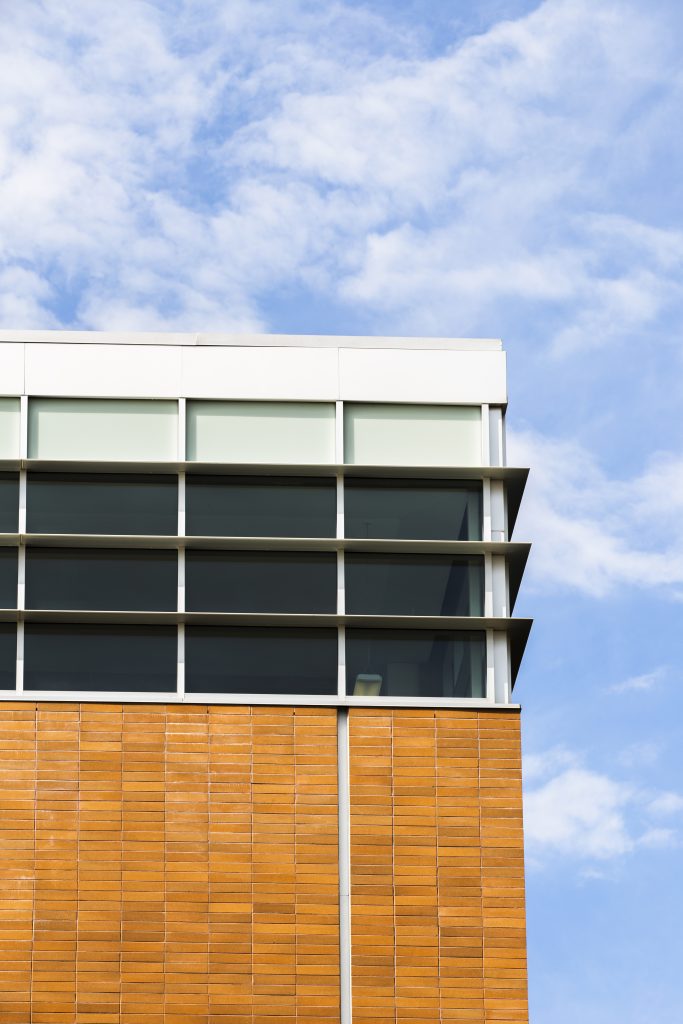 low angle building with windows brick wall
