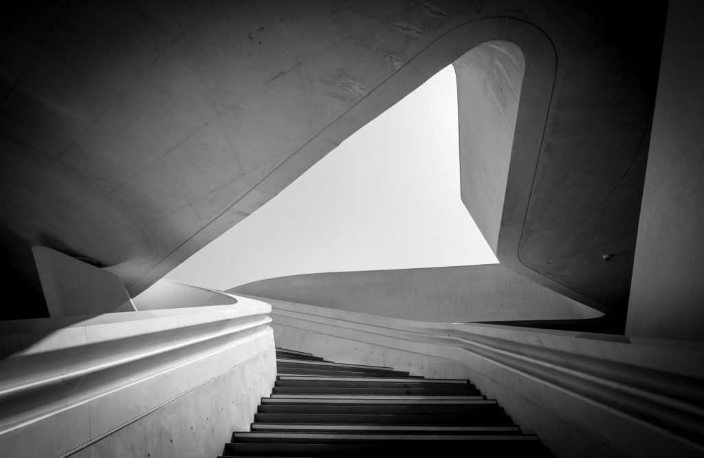 Modern architecture and empty staircase leading to a bright open space.