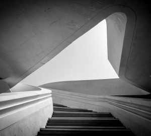 Modern architecture and empty staircase leading to a bright open space.